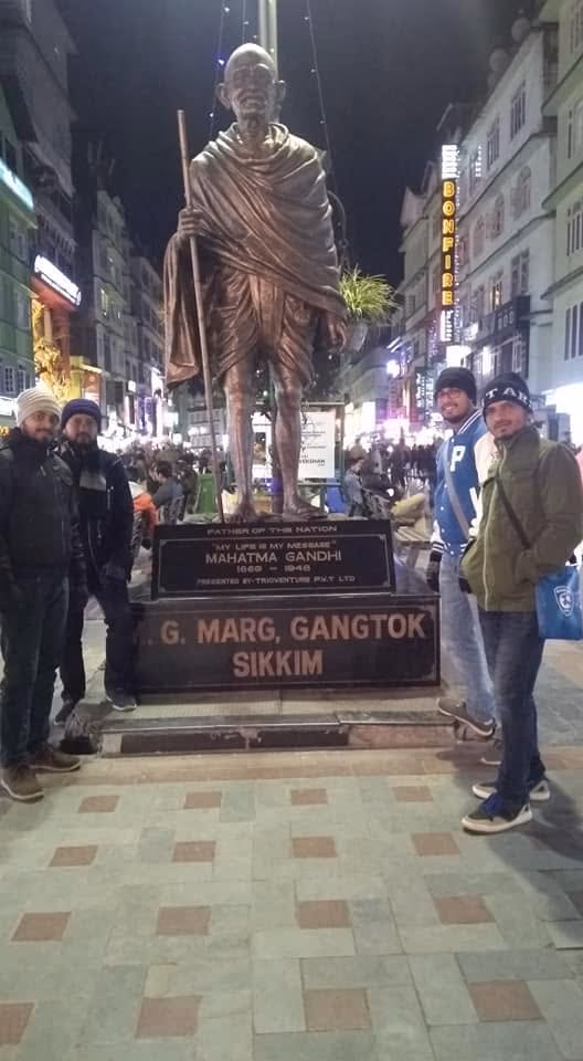 Statue of Mahatma Gandhi lit at night on M.G. Marg, Gangtok